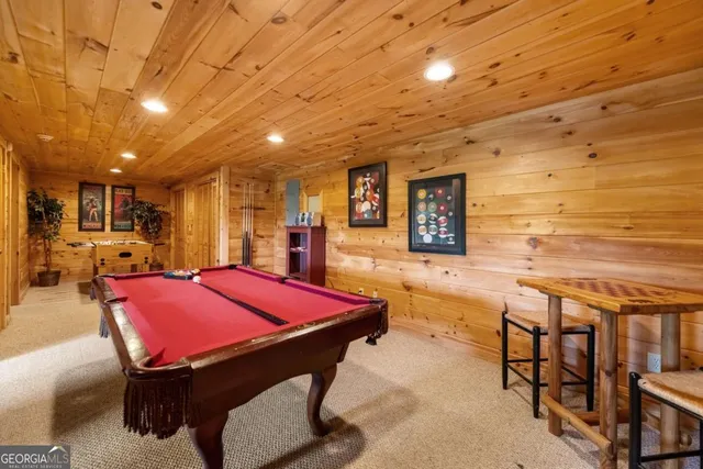 a front view of a house with a yard and large tree