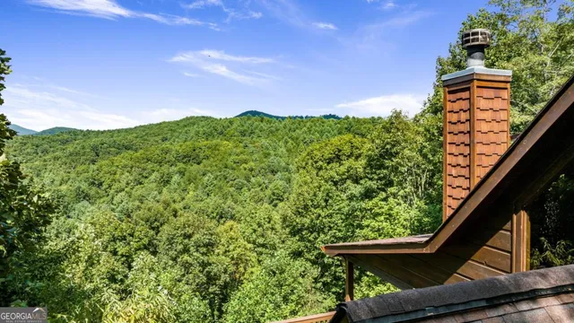 a view of a chairs and table in the balcony