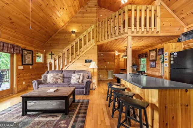 a living room with furniture a fireplace and a large window