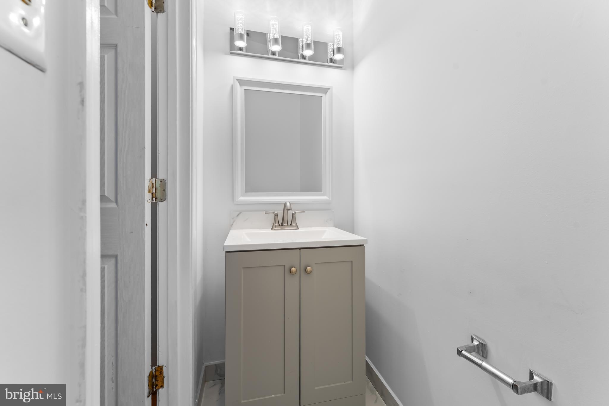 9443 Fields Road Gaithersburg, MD 20878 - Photo 11 of 27 a bathroom with a sink and mirror