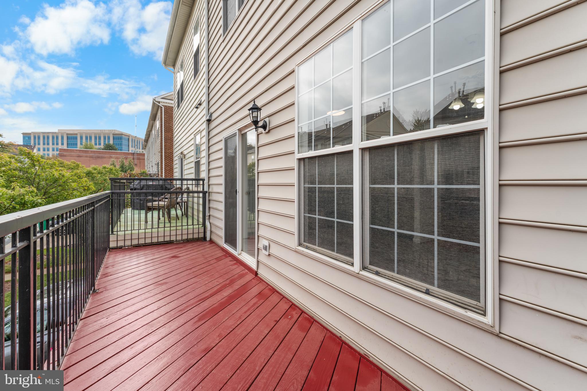 9443 Fields Road Gaithersburg, MD 20878 - Photo 17 of 27 a view of balcony with wooden floor and fence