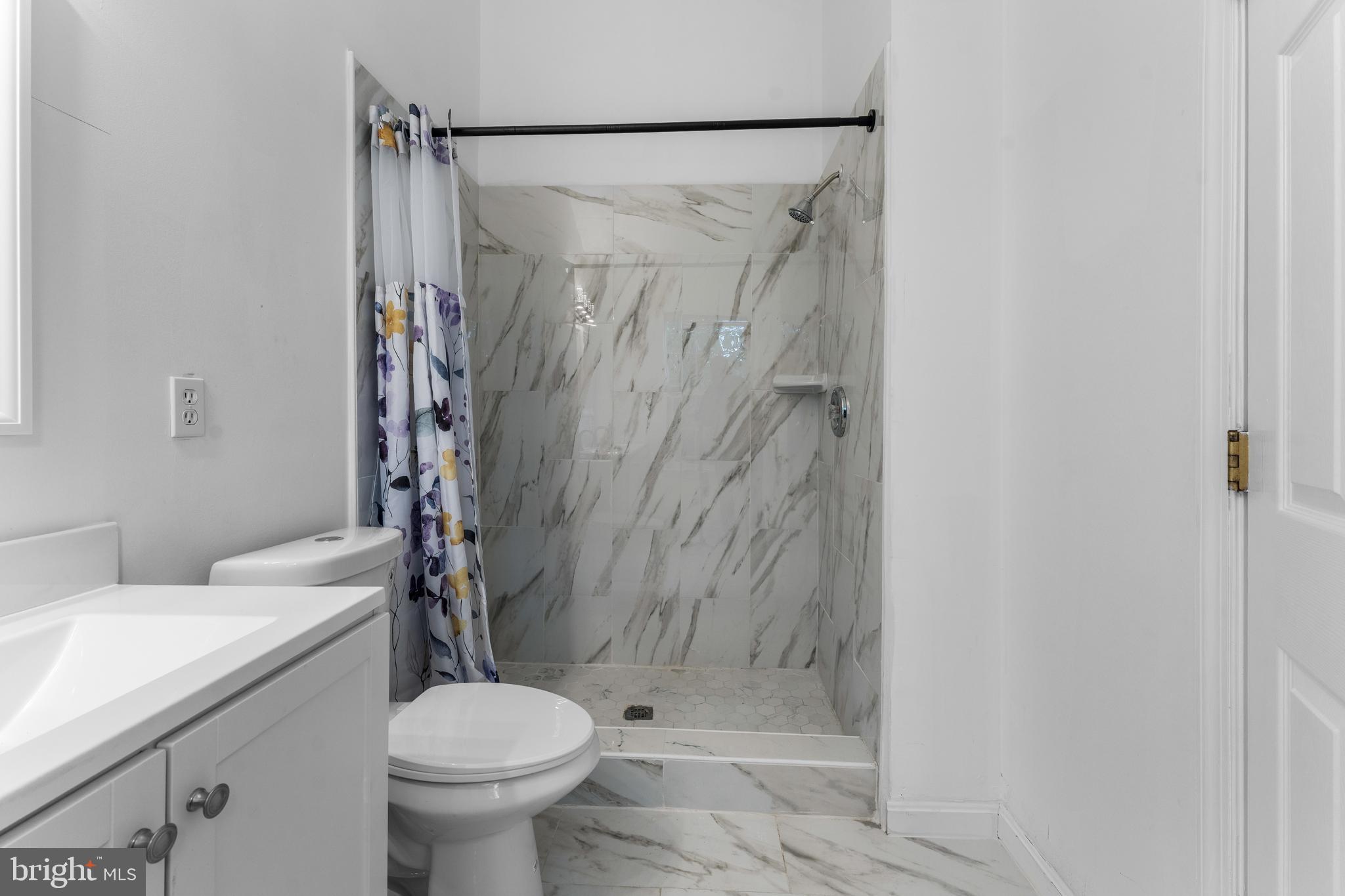 9443 Fields Road Gaithersburg, MD 20878 - Photo 23 of 27 a bathroom with a shower and a toilet