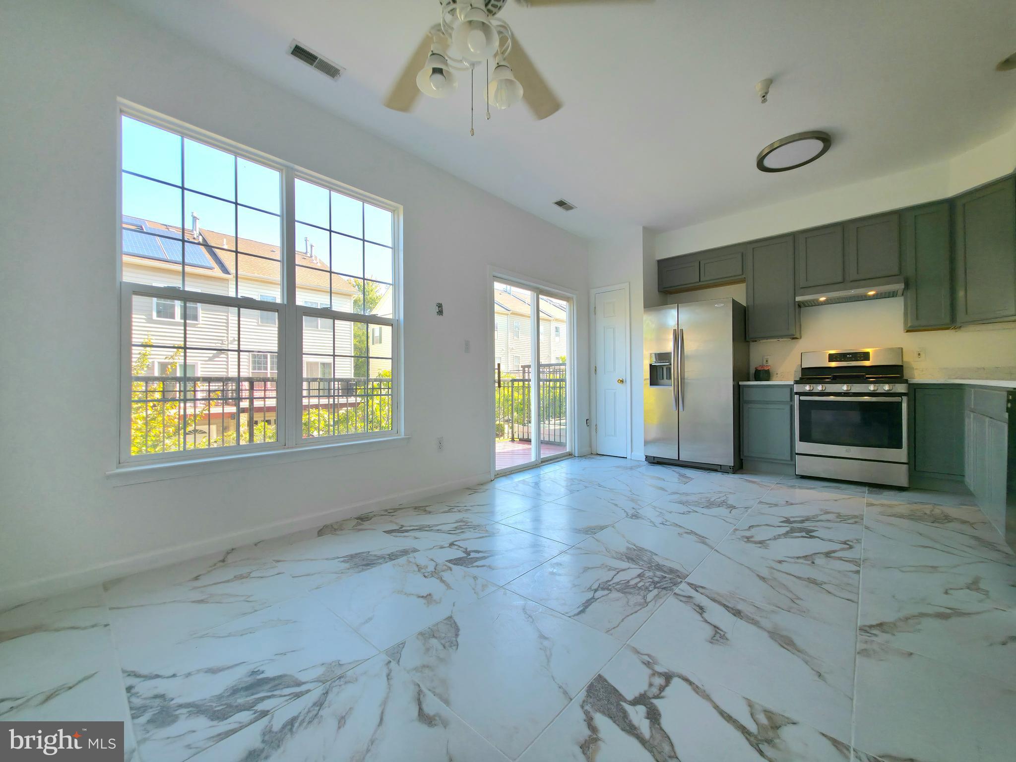 9443 Fields Road Gaithersburg, MD 20878 - Photo 7 of 27 a view of an empty room with a kitchen
