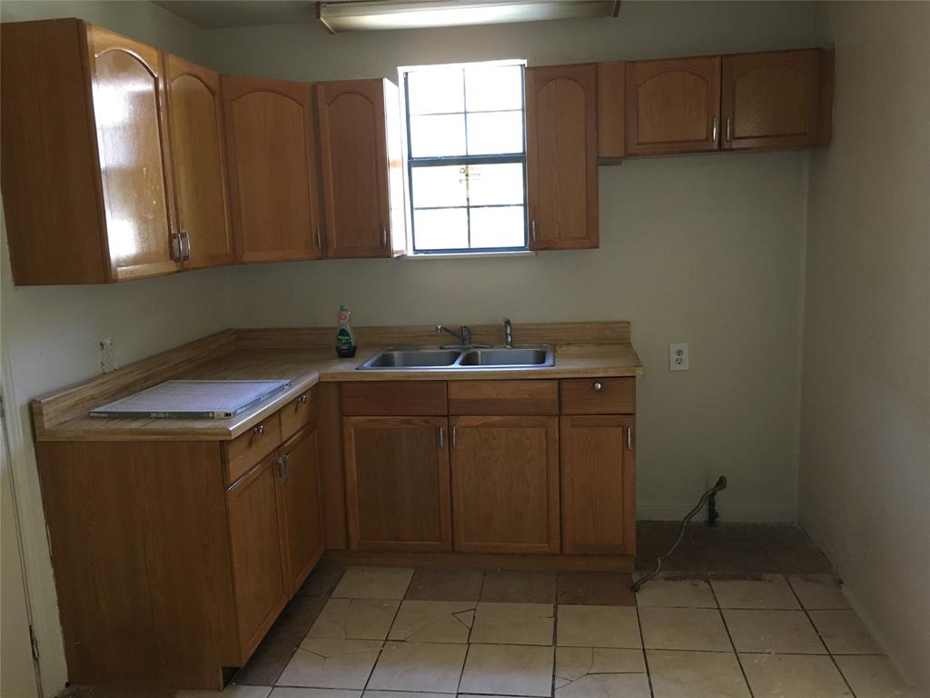 4623 Spring Garden Street Dallas, TX 75215 - Photo 6 of 12 a utility room with cabinets washer and dryer