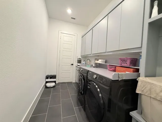 a utility room with sink dryer and washer