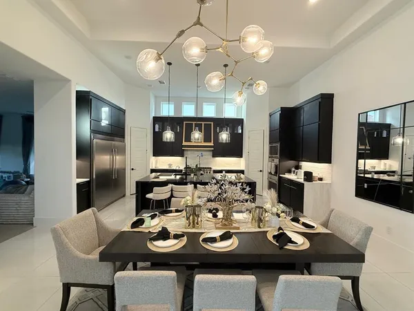 a view of a dining room with furniture and a flat screen tv