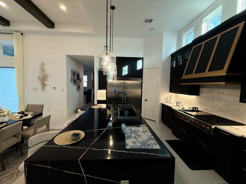 12314 Compassplant Drive Frisco, TX 75035 - Photo 17 of 40 a kitchen with a stove and a refrigerator