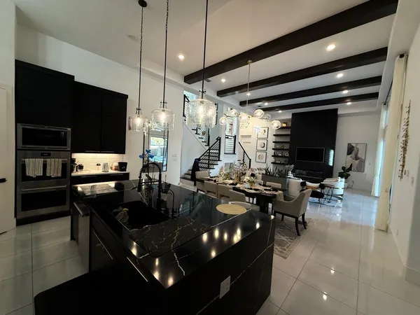 a kitchen with counter top space a sink and appliances
