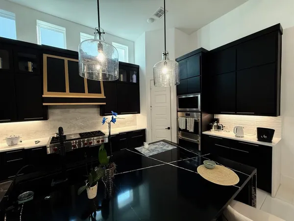 a kitchen with a sink a stove and refrigerator