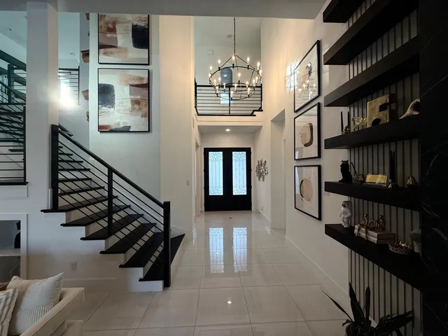 a view of entryway and hall with wooden floor