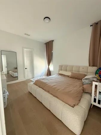a bedroom with a bed and a mirror