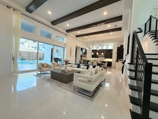 a living room with fireplace furniture and a large window