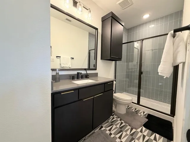 a bathroom with a sink toilet and shower