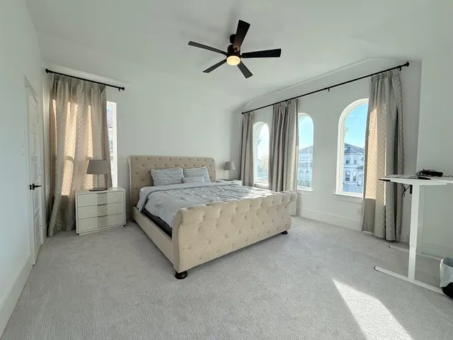 a bedroom with a bed dresser and a window