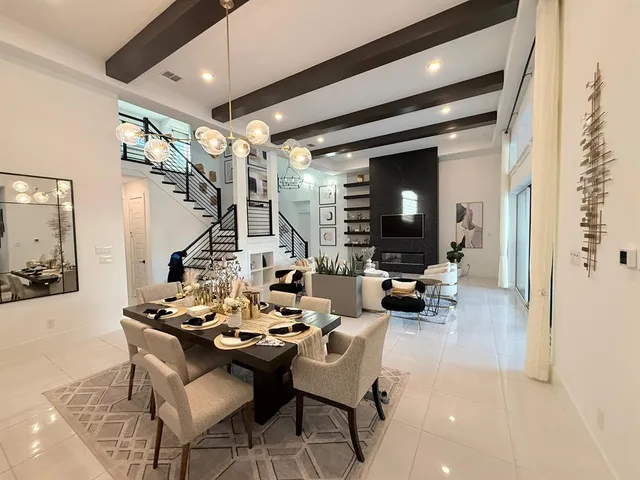 a living room with fireplace furniture and a chandelier