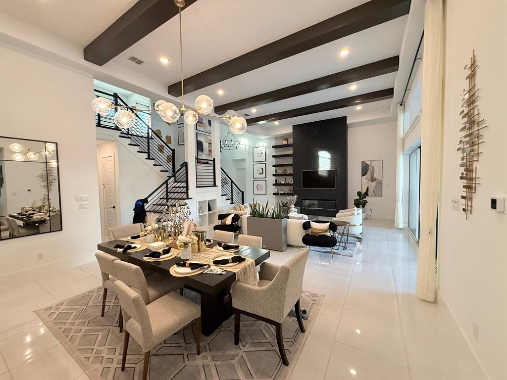 12314 Compassplant Drive Frisco, TX 75035 - Photo 6 of 40 a living room with fireplace furniture and a chandelier