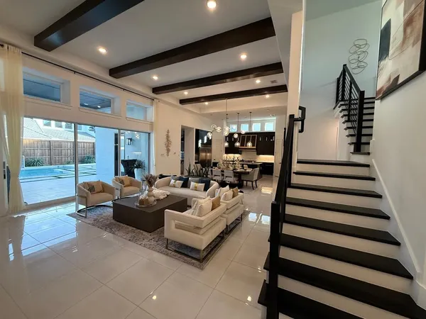a living room with furniture and a chandelier