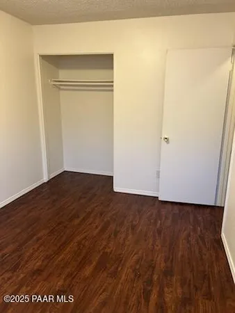 an empty room with wooden floor door