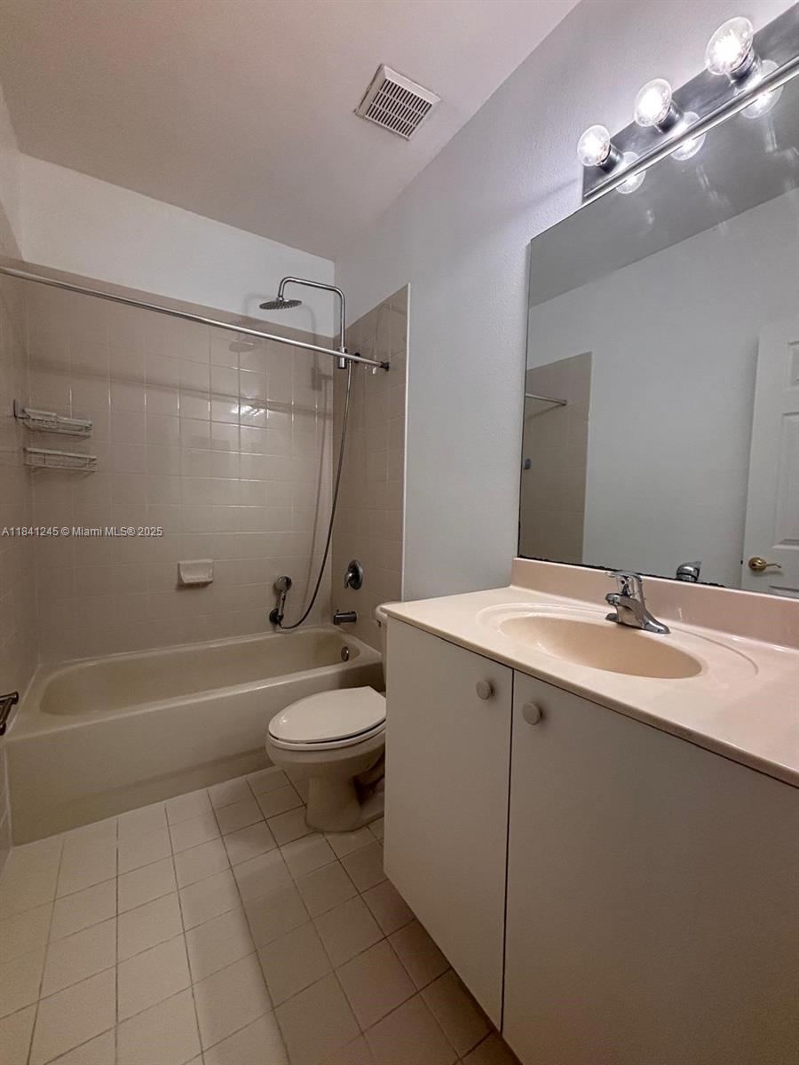 8491 Southwest 27th Street, Unit 101 Miramar, FL 33025 - Photo 9 of 10 a bathroom with a sink a toilet and shower