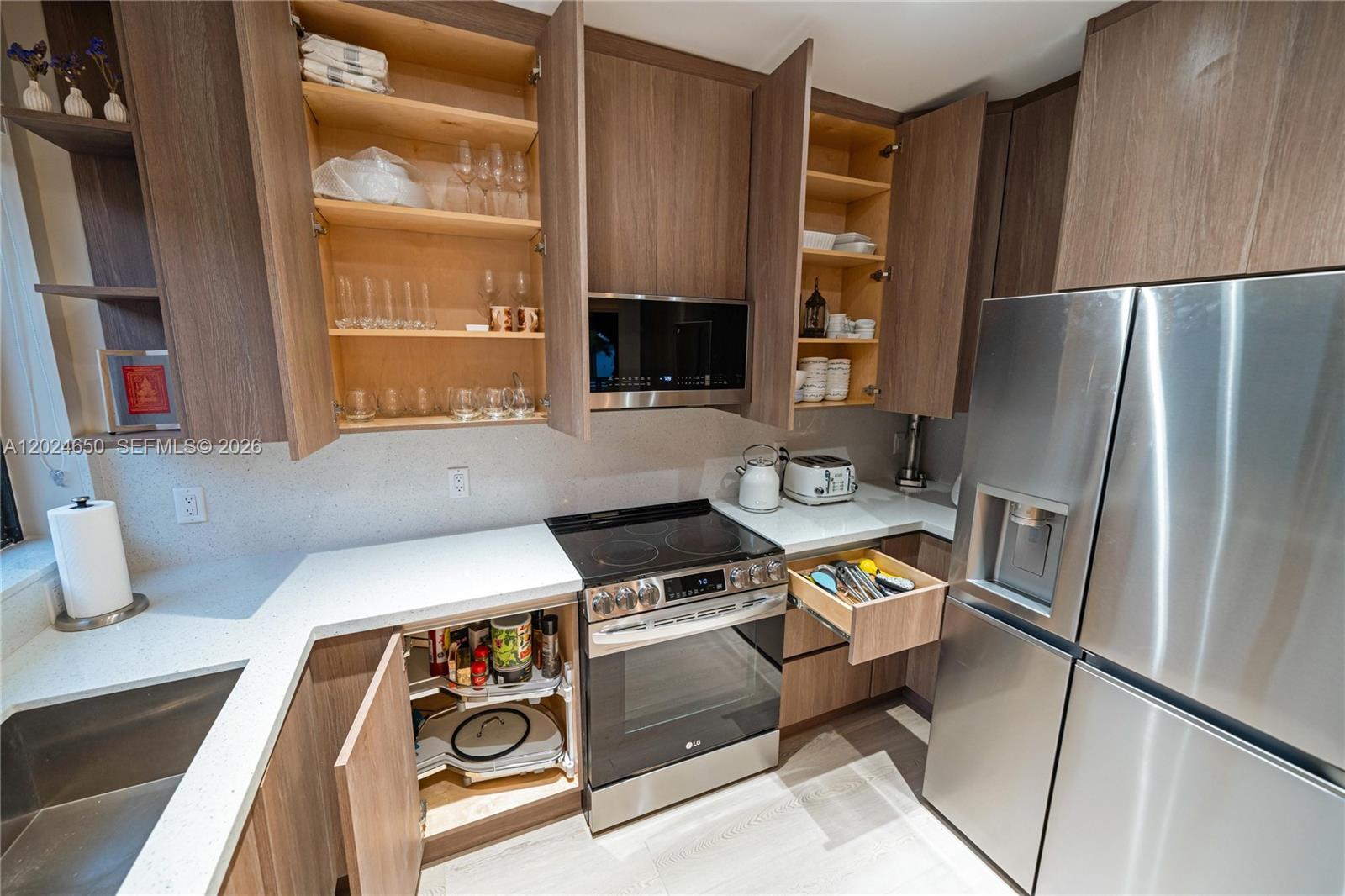 1663 Southwest 13th Street Miami, FL 33145 - Photo 71 of 112 a kitchen with stainless steel appliances granite countertop a refrigerator and a stove