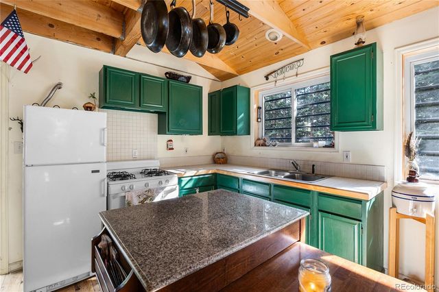 a view of kitchen with a table and chairs