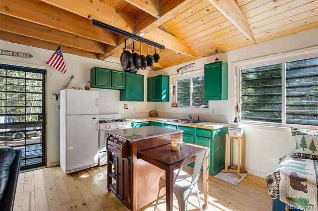 a kitchen with a sink a stove and cabinets
