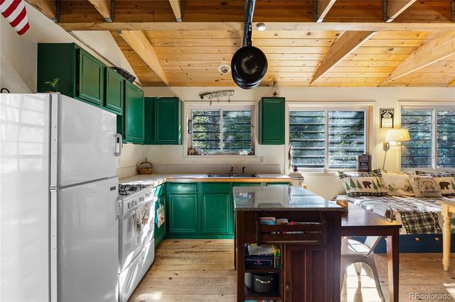a kitchen with a sink a stove and a refrigerator