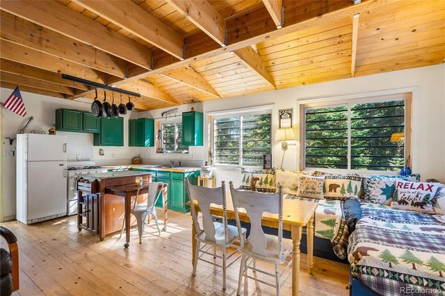 a view of a dining hall with furniture and wooden floor
