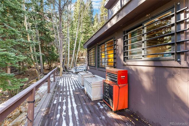 a view of a balcony with two chairs and a rug