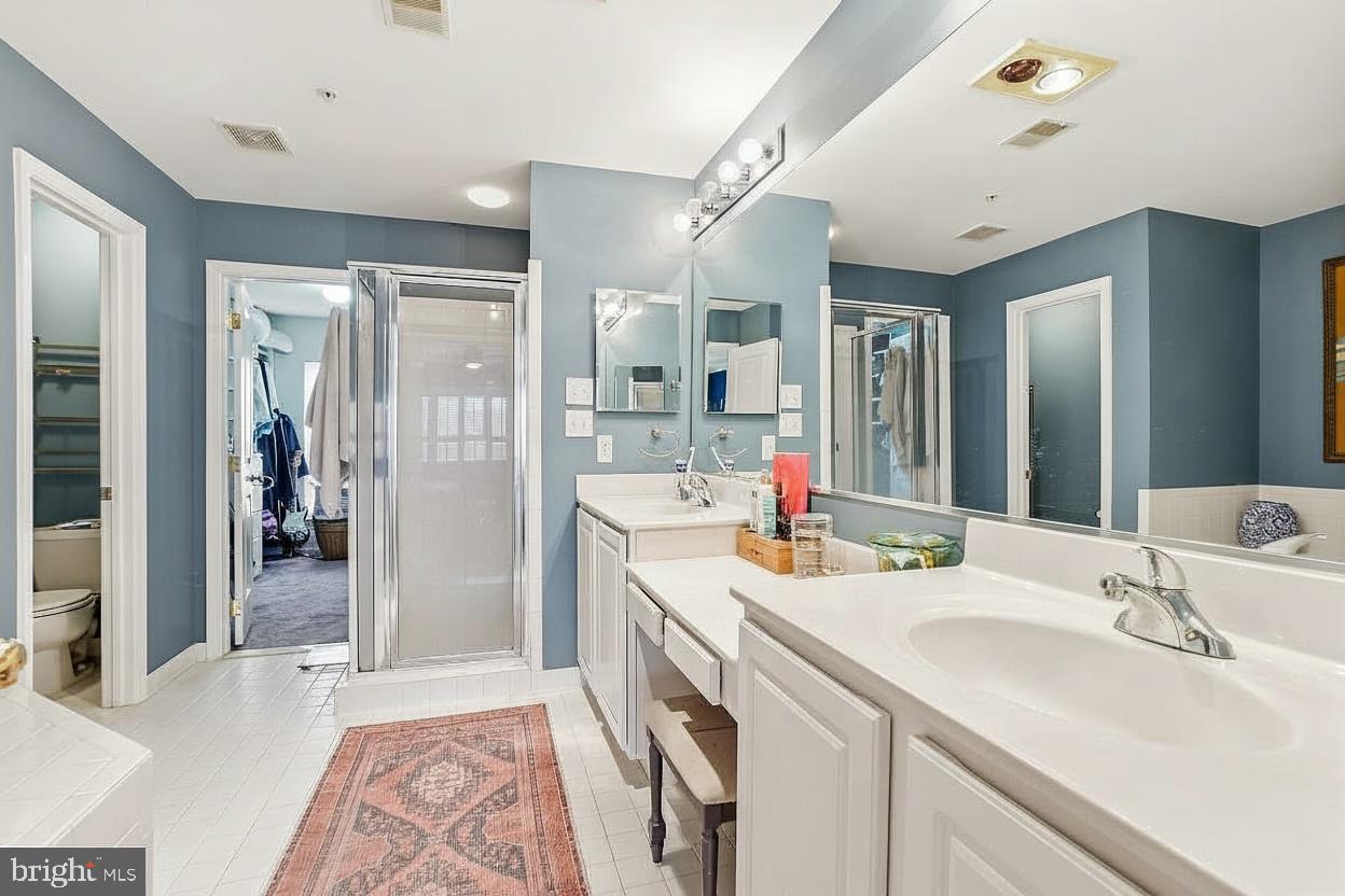 23416 Clarksridge Road Clarksburg, MD 20871 - Photo 25 of 48 a bathroom with a sink double vanity granite tub shower and a mirror