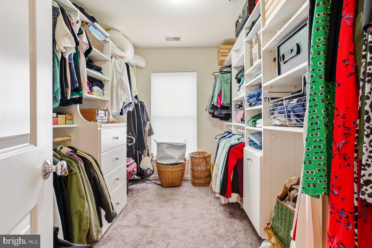 23416 Clarksridge Road Clarksburg, MD 20871 - Photo 27 of 48 a view of walk in closet with clothes and shoes