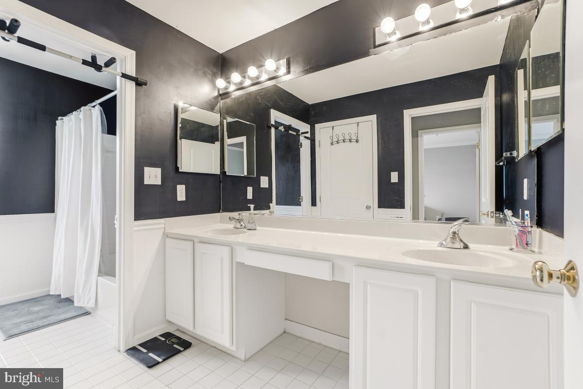 23416 Clarksridge Road Clarksburg, MD 20871 - Photo 34 of 48 a bathroom with a double vanity sink and a mirror