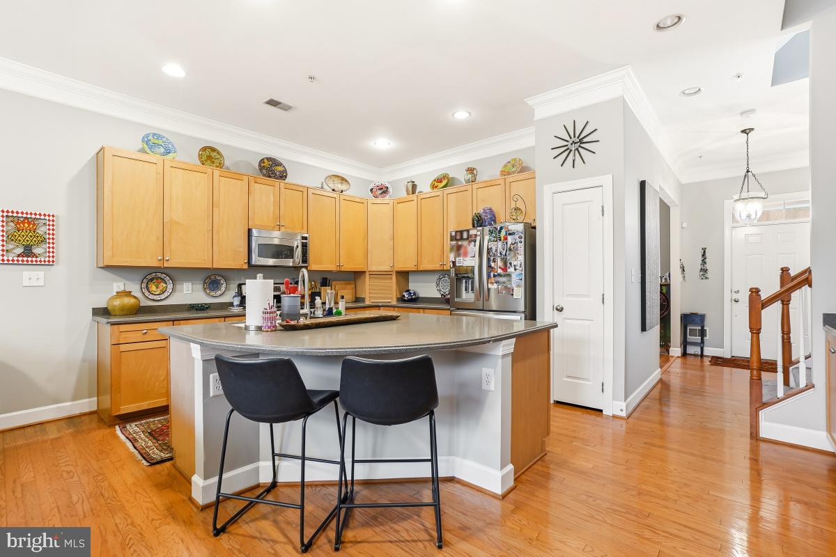 23416 Clarksridge Road Clarksburg, MD 20871 - Photo 8 of 48 a kitchen with stainless steel appliances granite countertop a table chairs refrigerator and sink