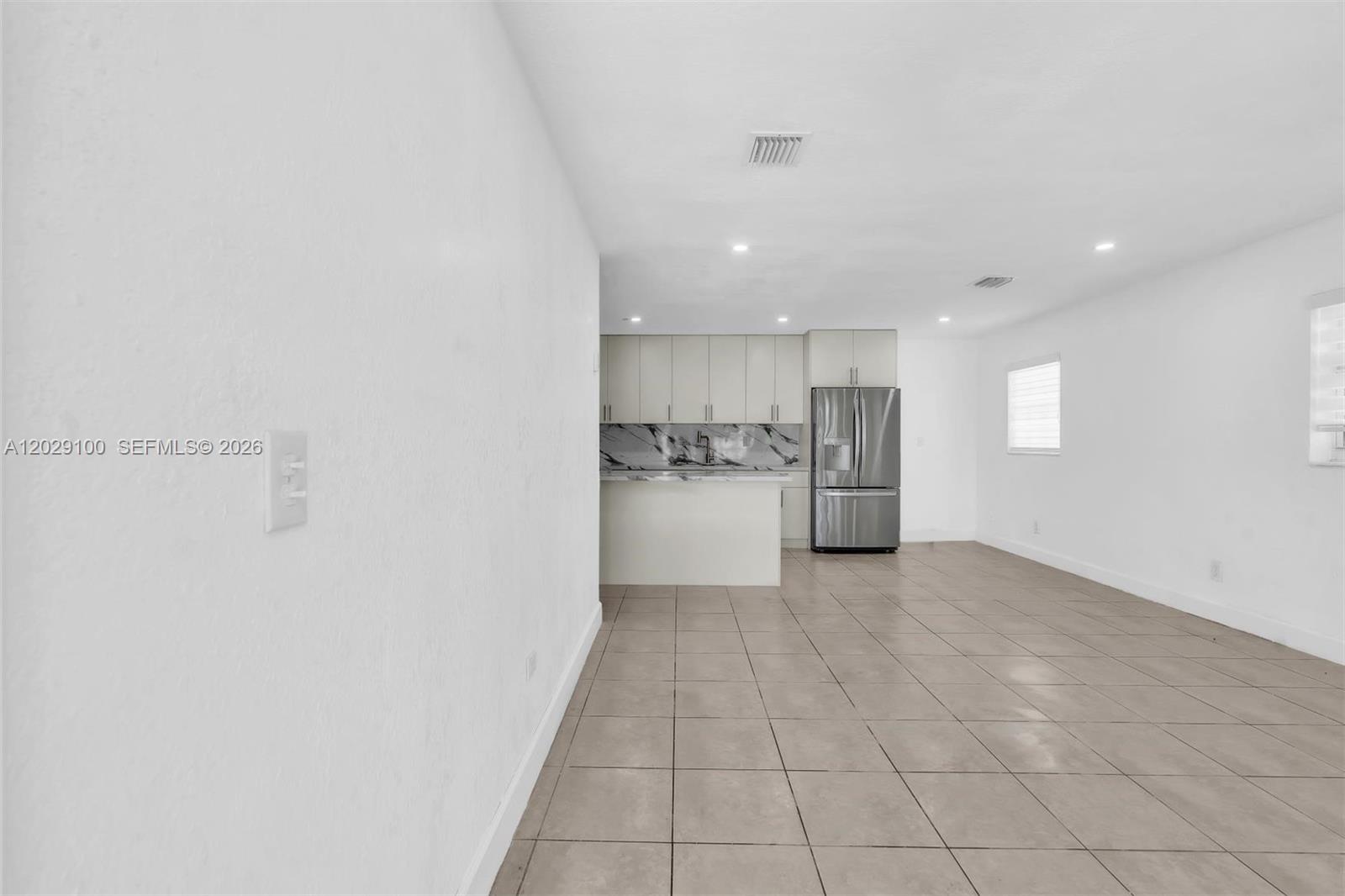 11790 Southwest 34th Street Miami, FL 33175 - Photo 8 of 56 a view of a kitchen with a sink and an empty room
