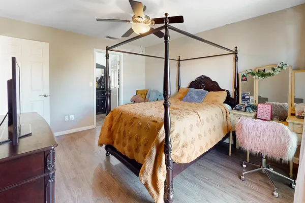 a bed room with a bed and a chair