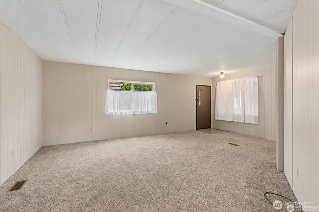 an empty room with windows and closet