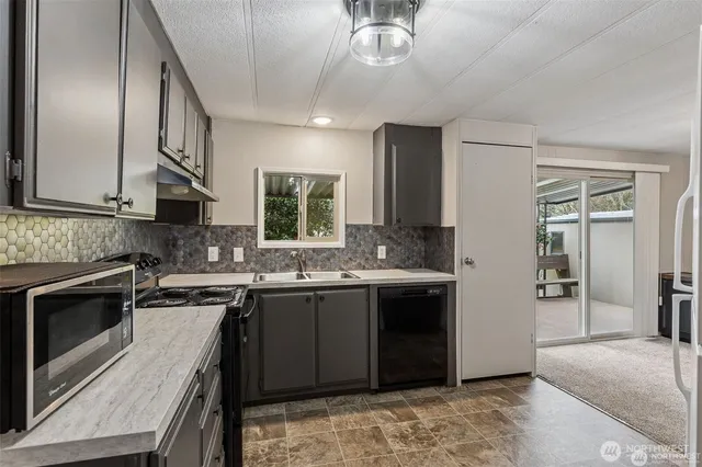 a kitchen with a sink and a stove top oven