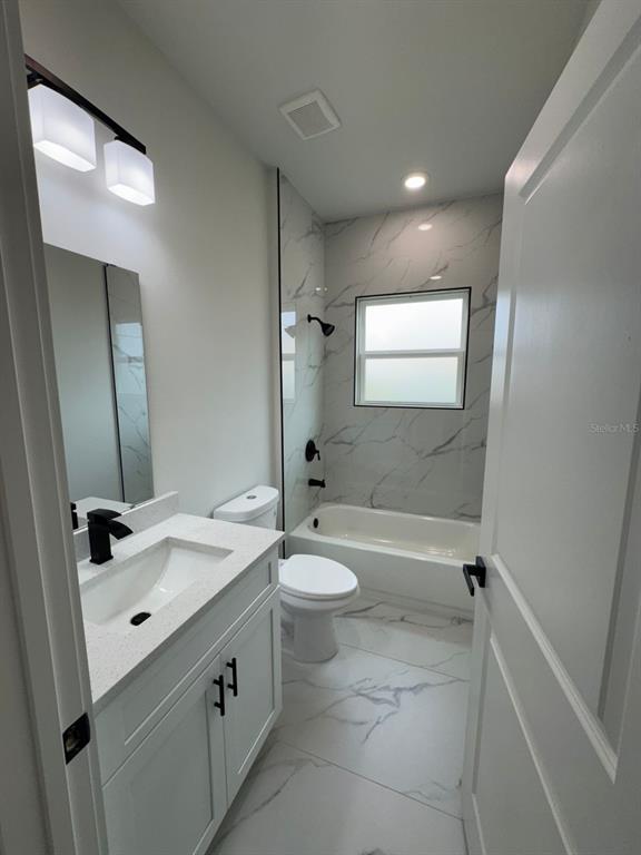 13385 Southwest 32nd Court Ocala, FL 34473 - Photo 7 of 20 a bathroom with a double vanity sink toilet mirror and shower