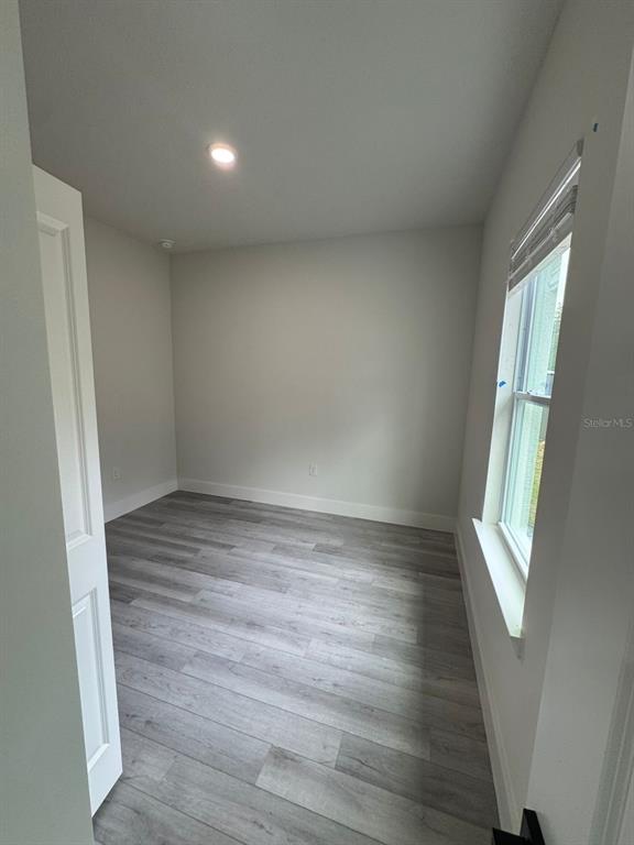 13385 Southwest 32nd Court Ocala, FL 34473 - Photo 8 of 20 an empty room with wooden floor and windows