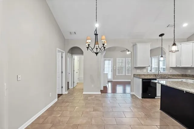 a view of a dining room with furniture and a chandelier
