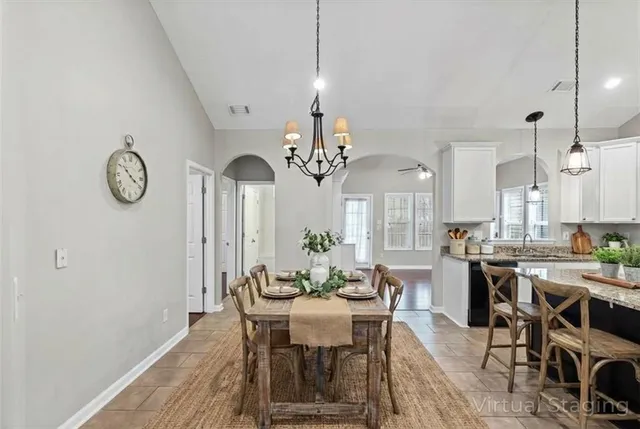 a kitchen with stainless steel appliances granite countertop a stove a sink dishwasher a refrigerator and a oven with wooden floor