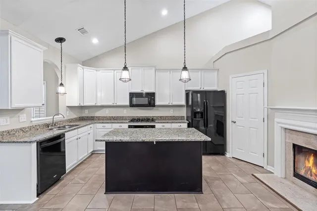 a kitchen with a stove top oven and cabinets