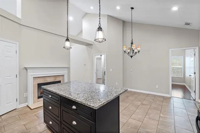 a kitchen with stainless steel appliances granite countertop a sink stove and cabinets