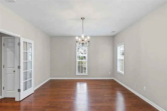a view of a room with wooden floor and window