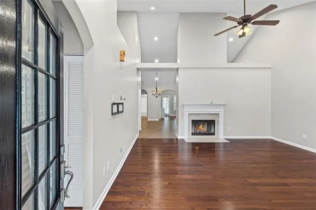 a view of a hallway view with fireplace and wooden floor