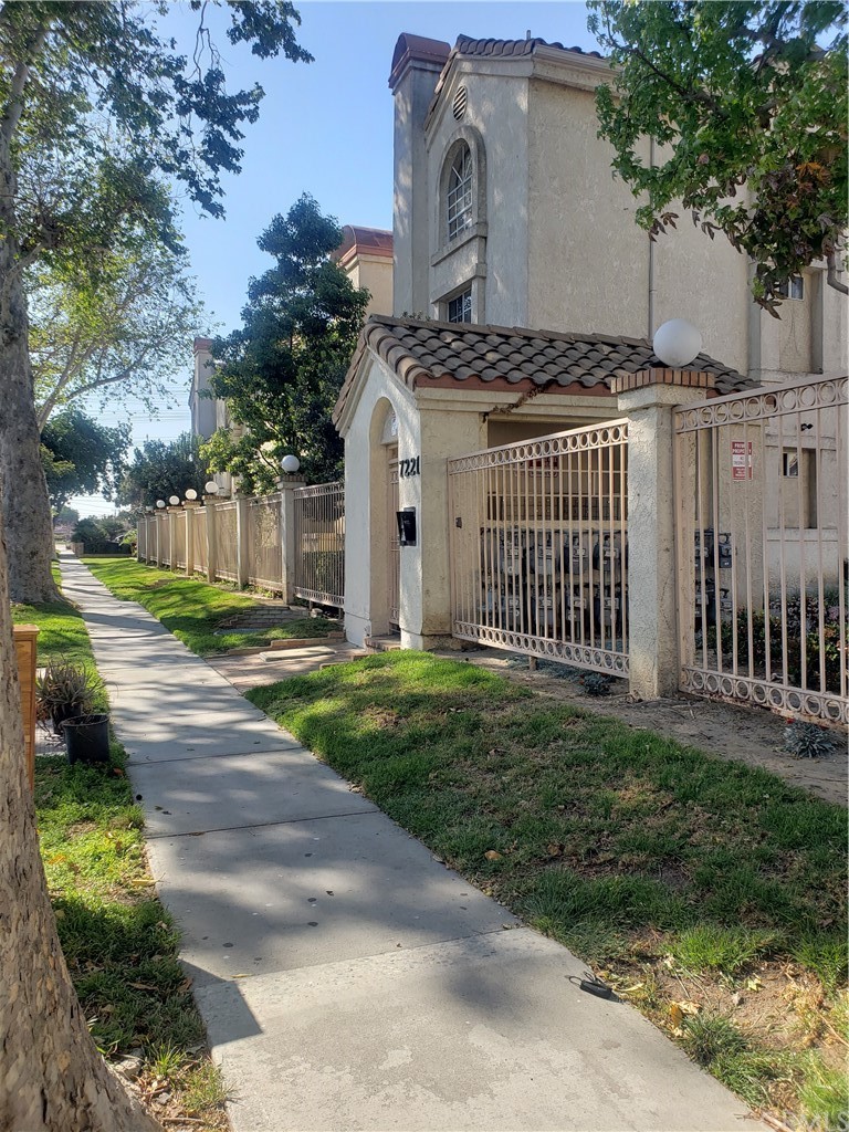 7221 Petrol Street, Unit 6 Paramount, CA 90723 - Photo 2 of 21 a front view of a house with a yard