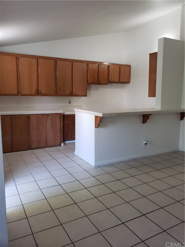 7221 Petrol Street, Unit 6 Paramount, CA 90723 - Photo 10 of 21 a kitchen with stainless steel appliances a cabinets and window