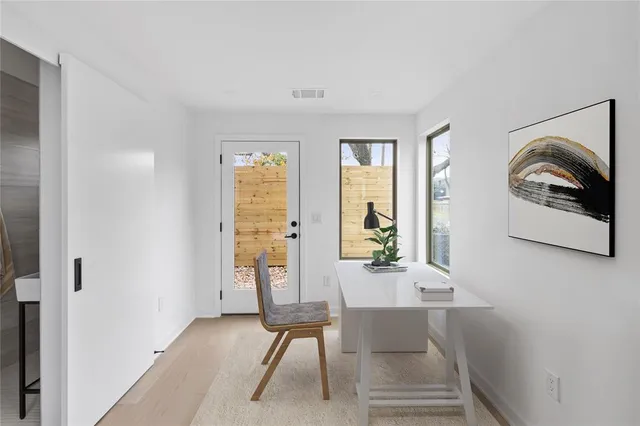 a view of a room with wooden floor and windows
