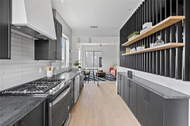 a kitchen with sink stove and cabinets