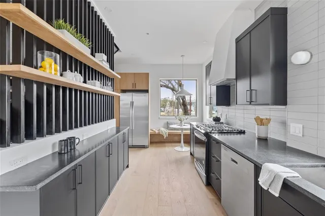 a kitchen with sink stove and cabinets